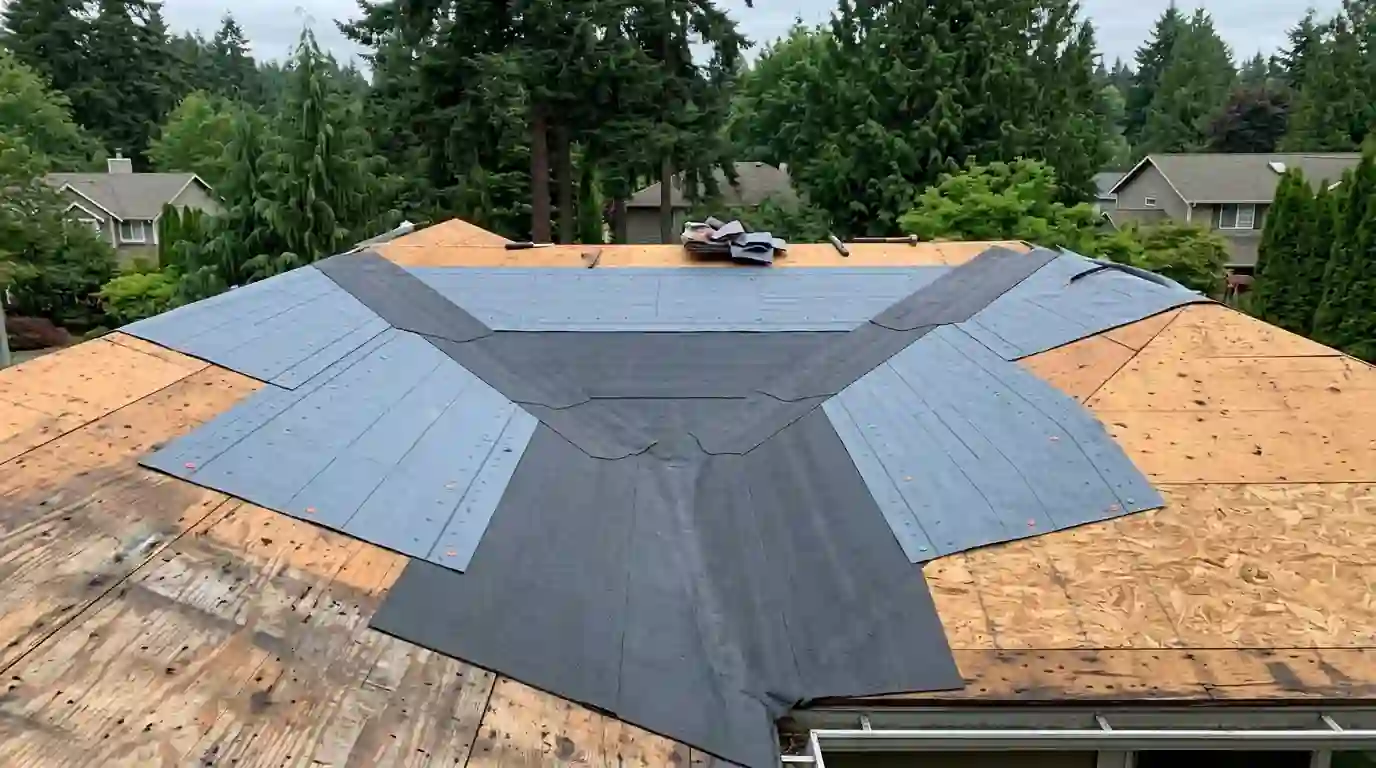 New underlayment and valley membrane on a bare roof deck